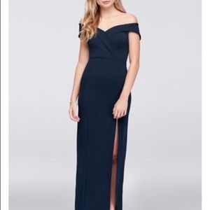 Davids bridal surplice neckline, cuffed off shoulder sleeves, and a slit skirt.